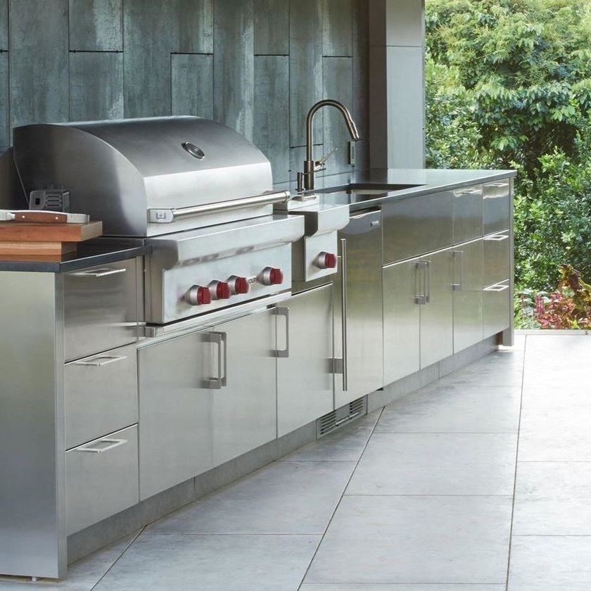 A stainless steel kitchen with a grill and sink