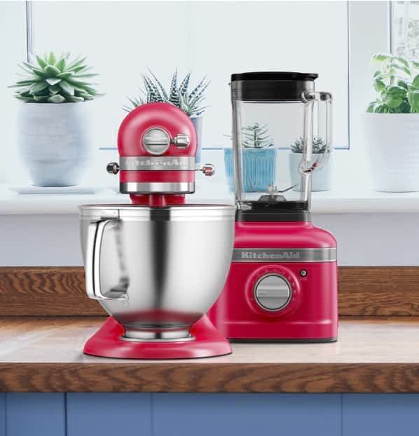 A red kitchenaid mixer and blender are on a counter