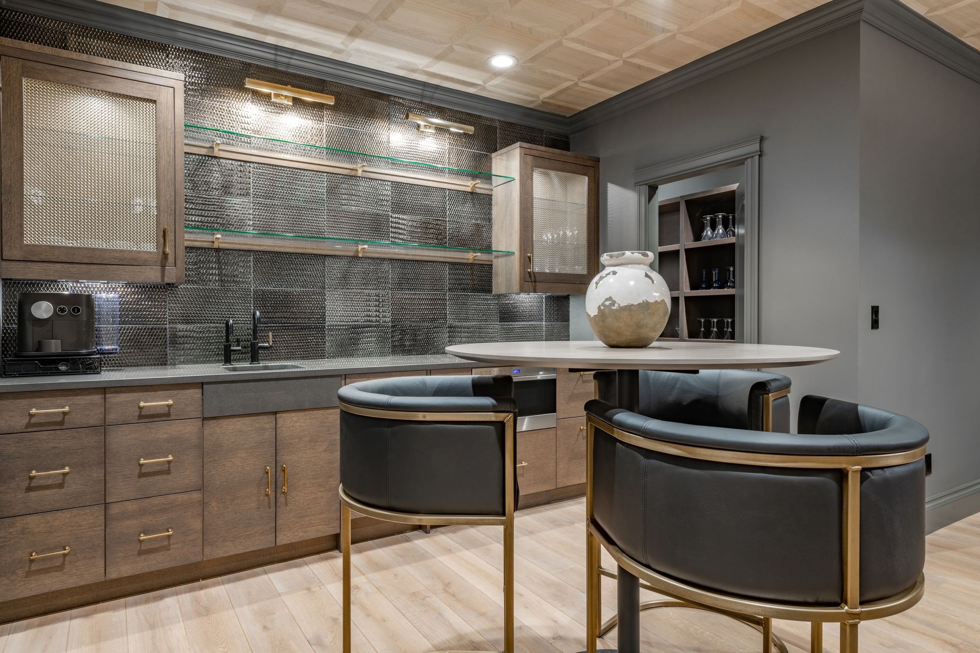 Two lamps and a vase on a table in front of a mirror