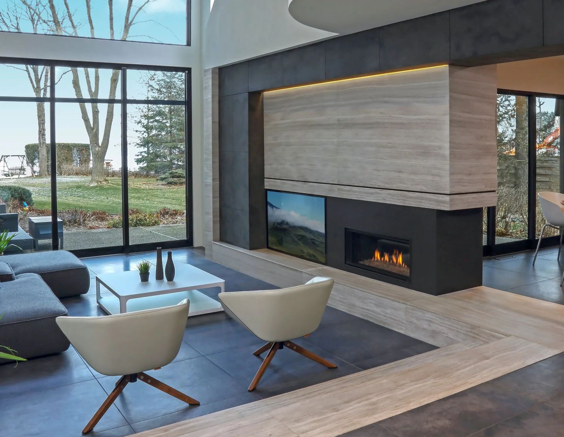 A living room with a fireplace and a lot of windows