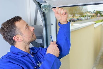 technician repairing door