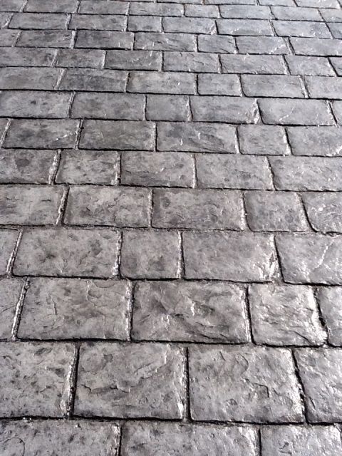 A close up of a brick floor with a diagonal pattern