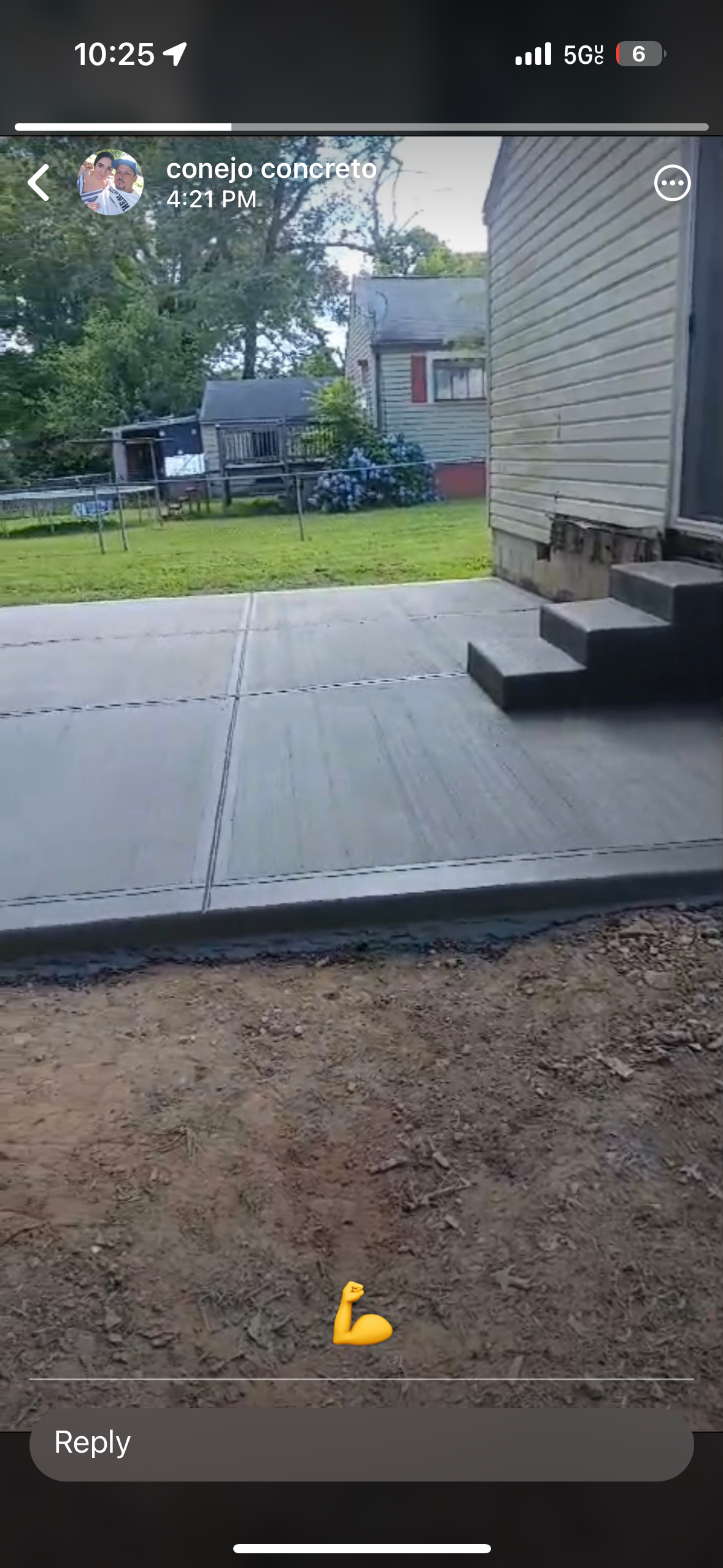 A phone screen shows a concrete patio being built in front of a house.
