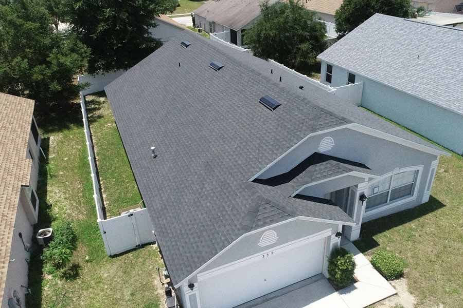 An aerial view of a house with a new roof.