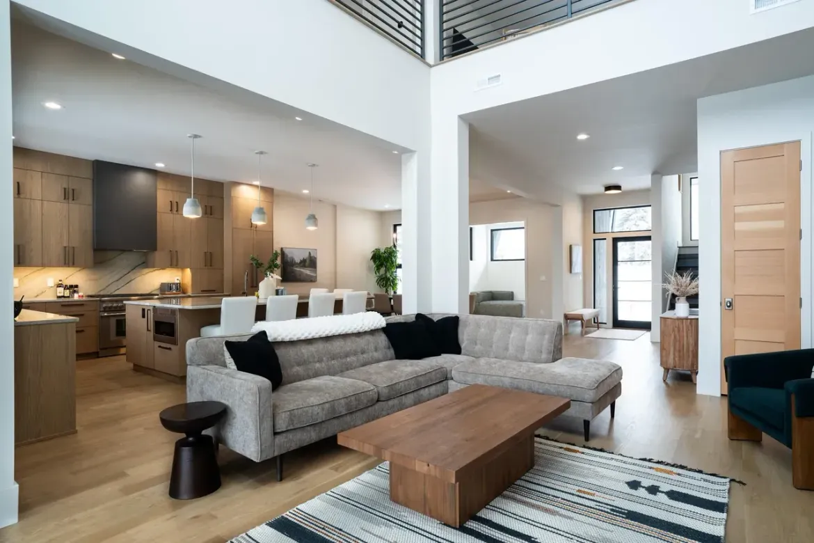 Interior view of modern home with large windows overlooking landscape.