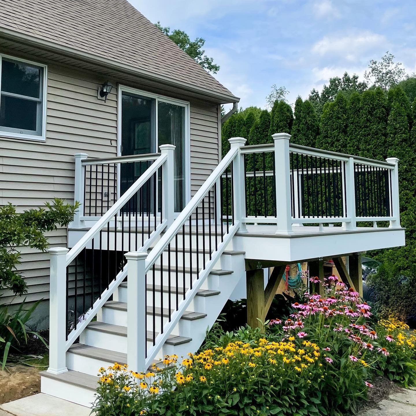 A house with a deck and stairs leading up to it