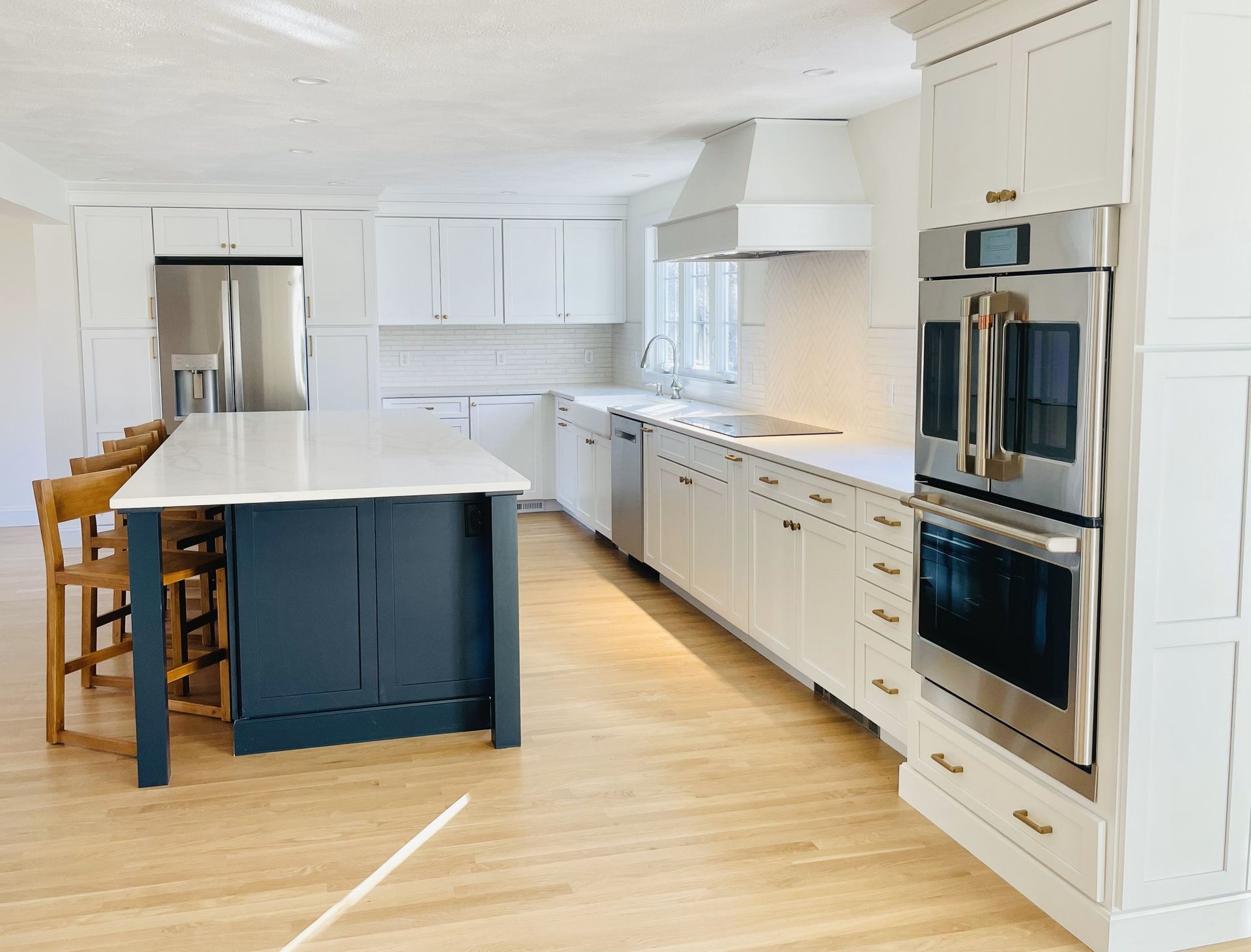 A kitchen with white cabinets and stainless steel appliances