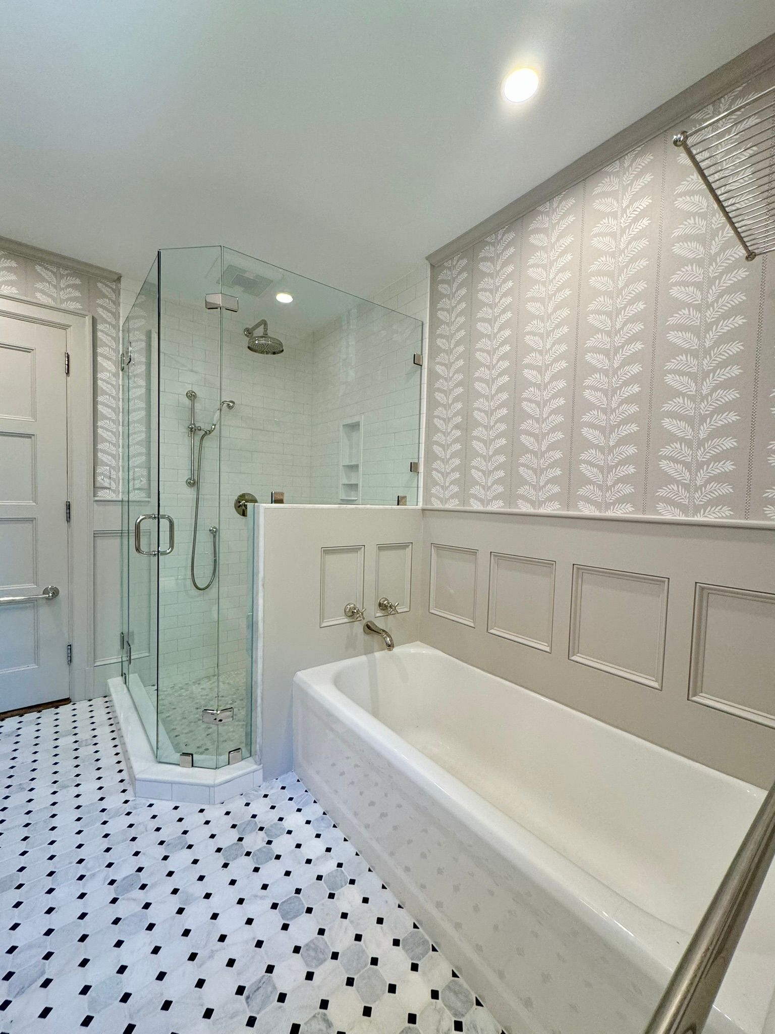 A bathroom with a bathtub and a walk in shower