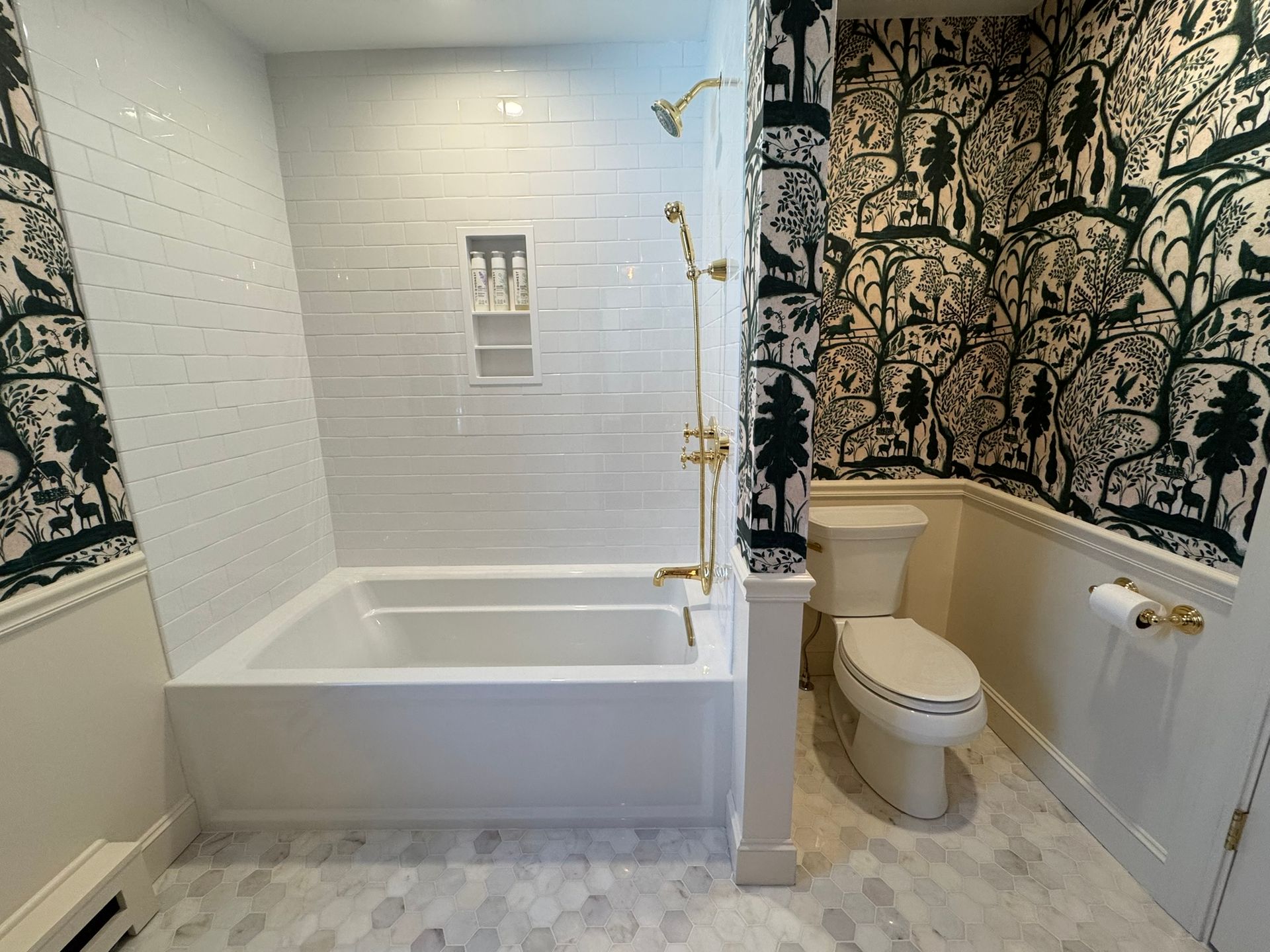 A bathroom with a bathtub , toilet and shower.