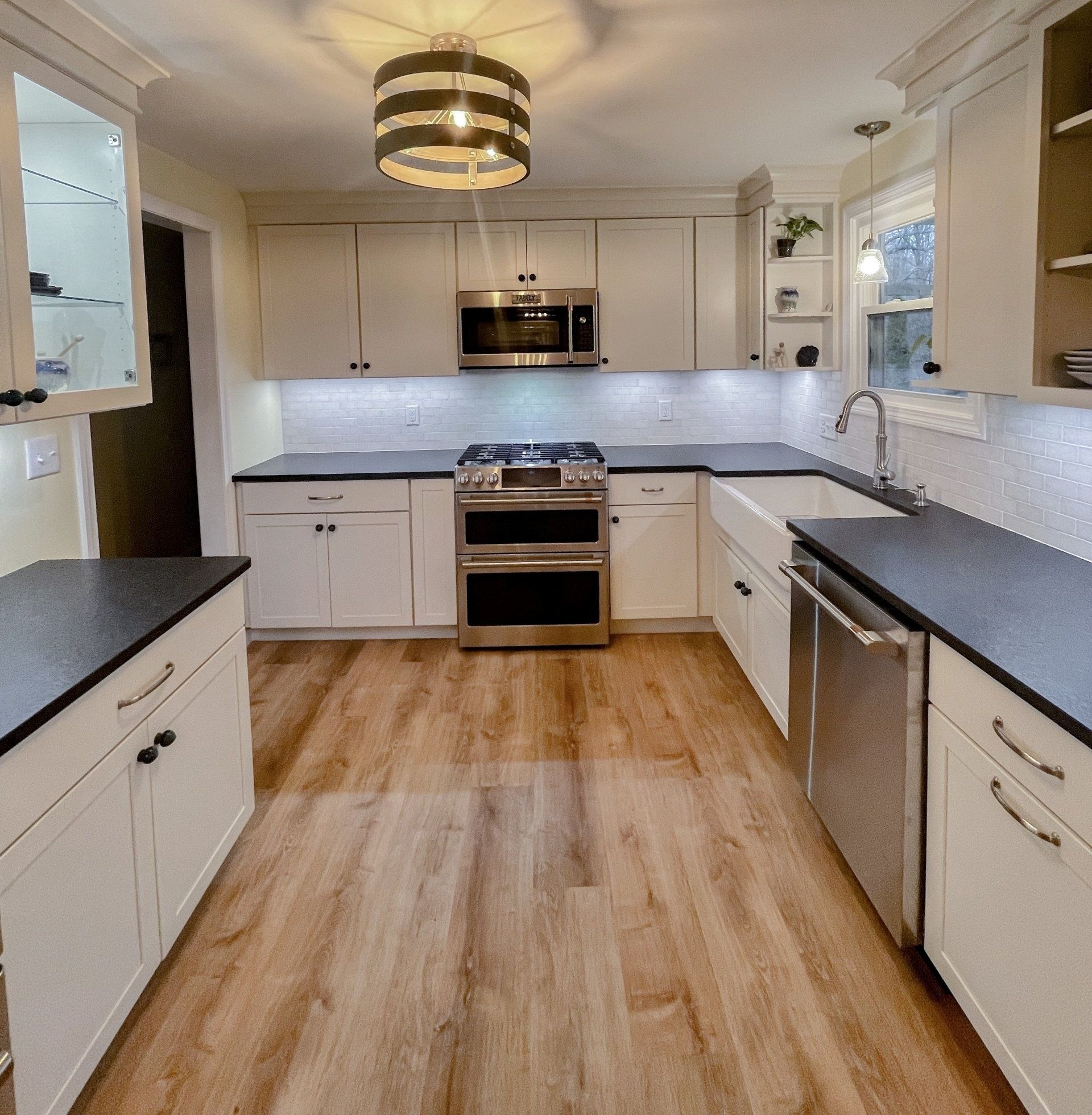 A kitchen with white cabinets and stainless steel appliances