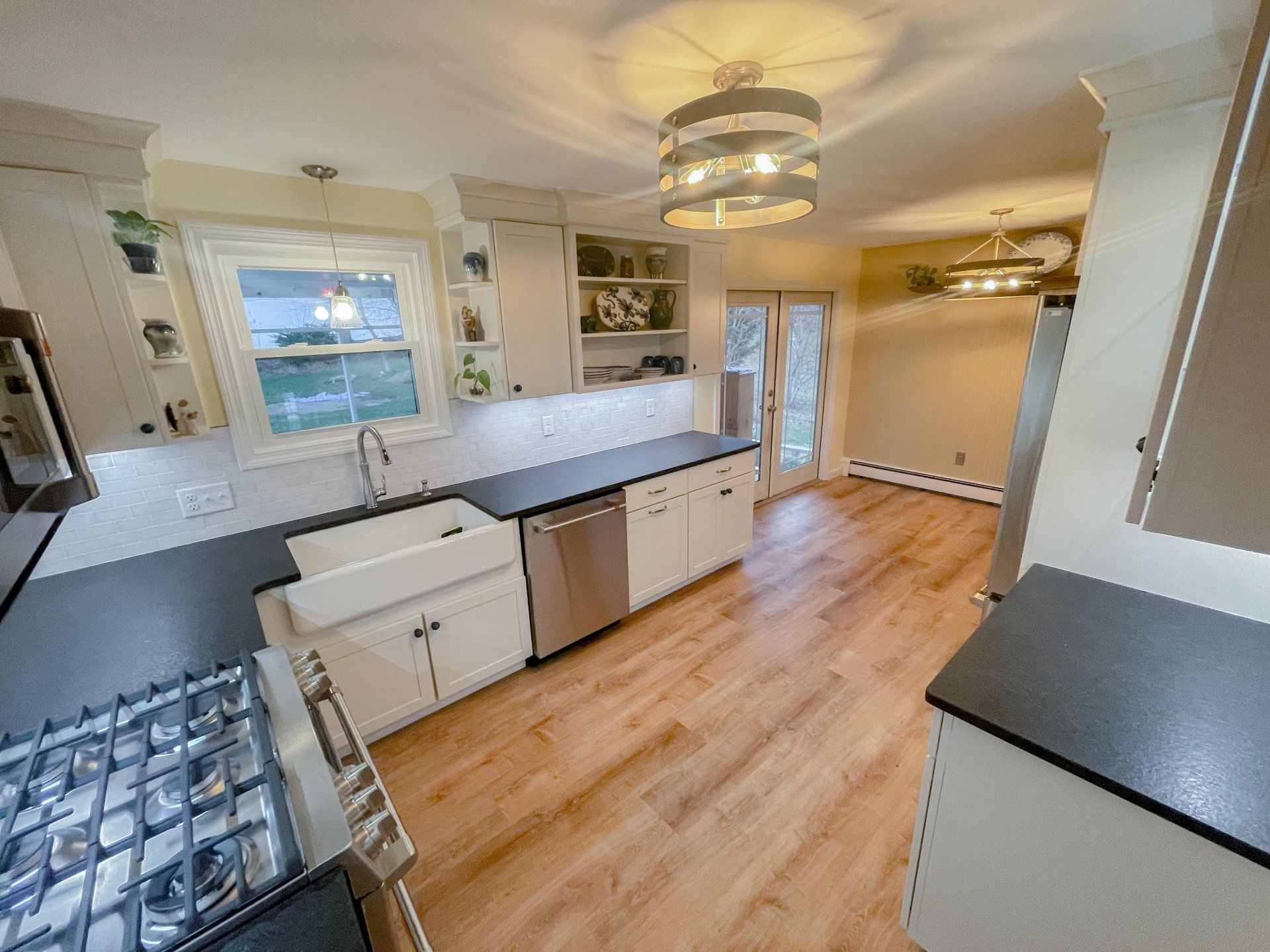 A kitchen with a stove , sink , and dishwasher.