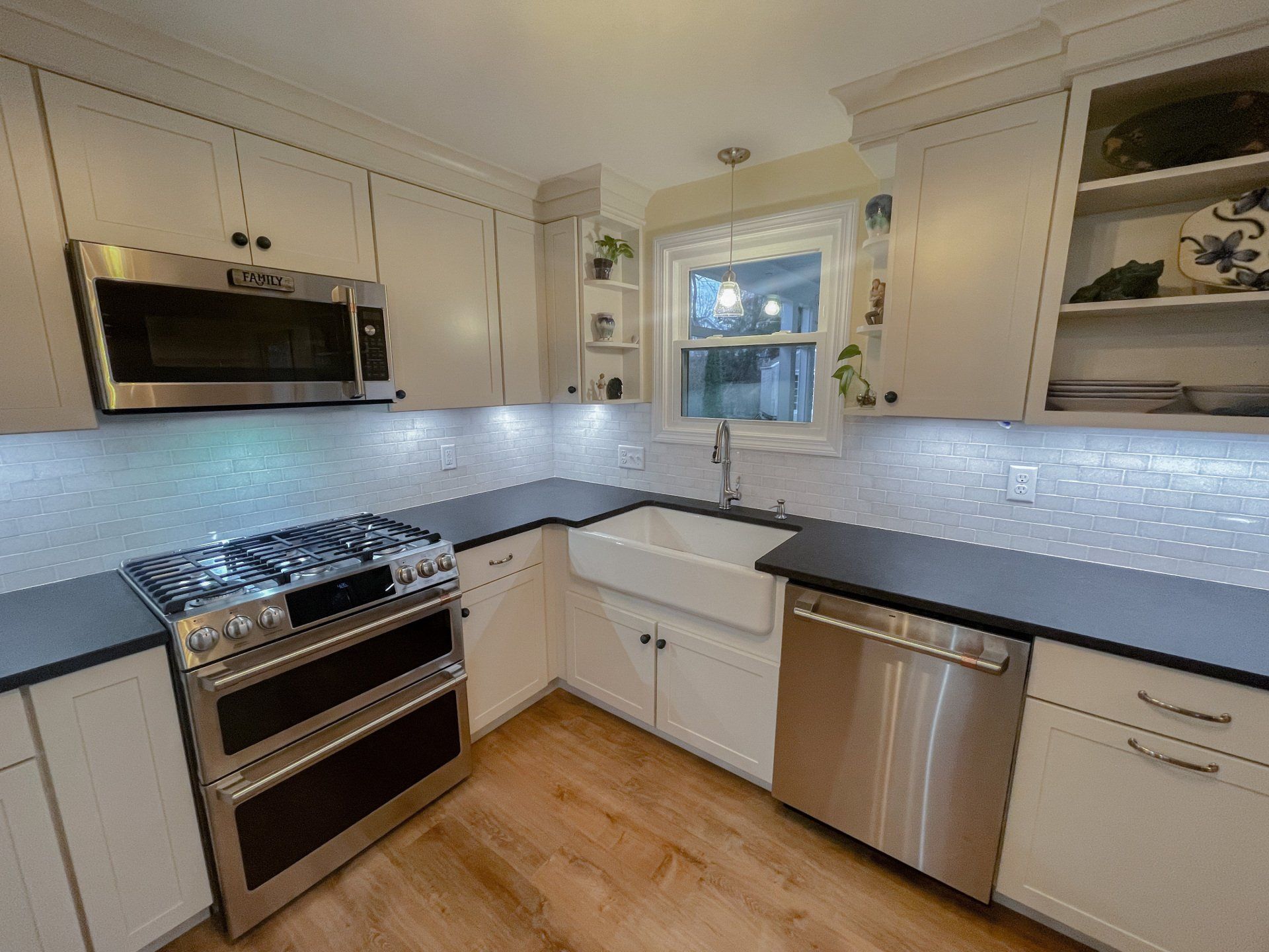 A kitchen with stainless steel appliances and white cabinets
