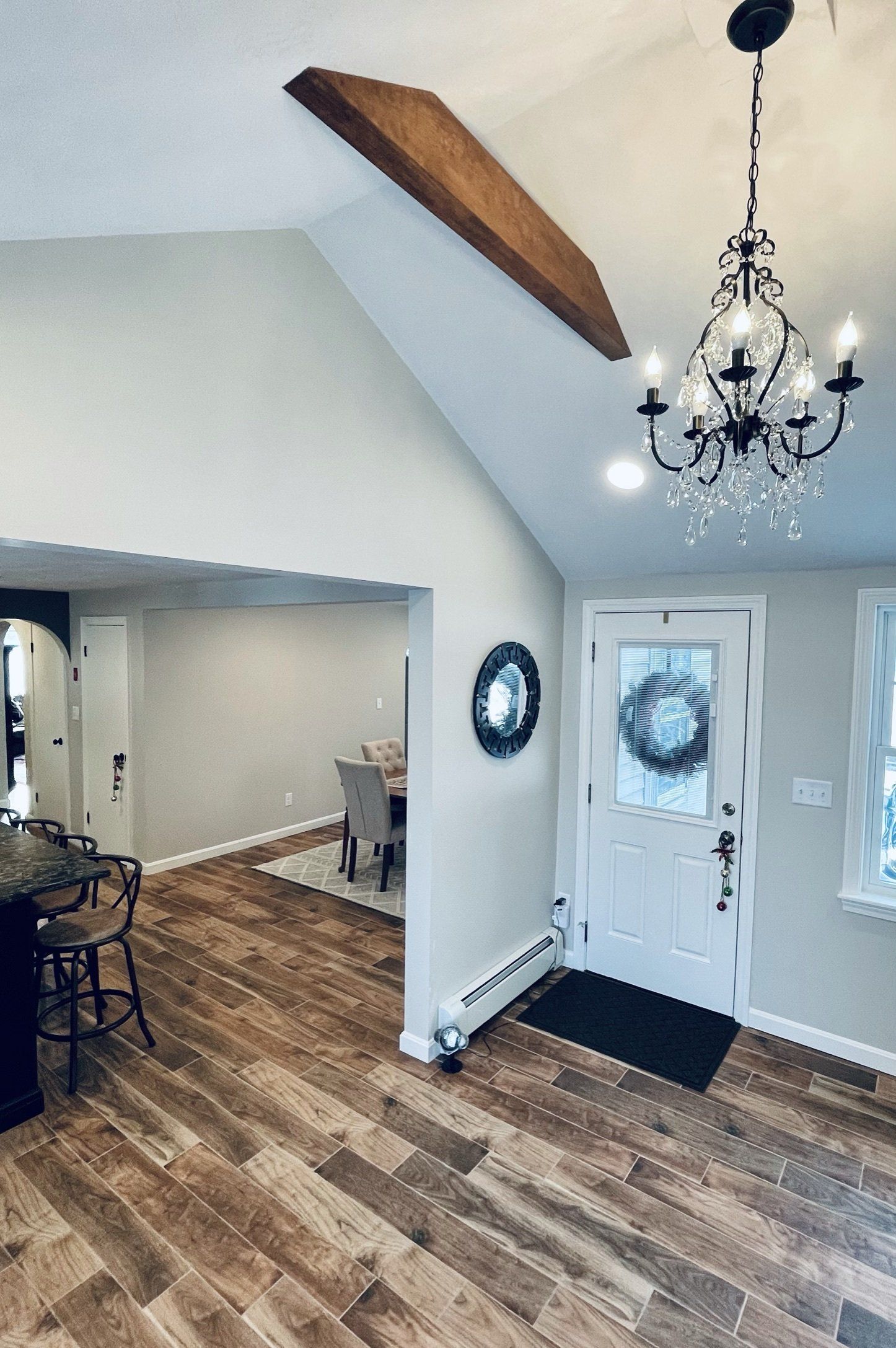 A living room with hardwood floors and a chandelier hanging from the ceiling.