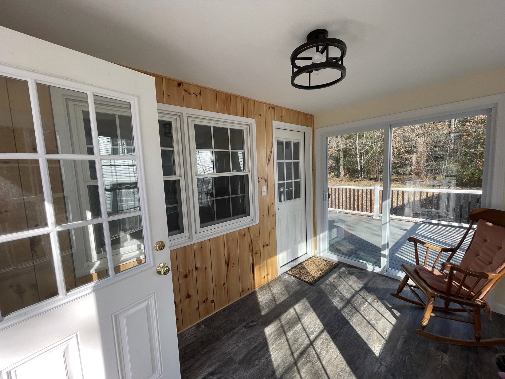 There is a rocking chair in the porch of a house.