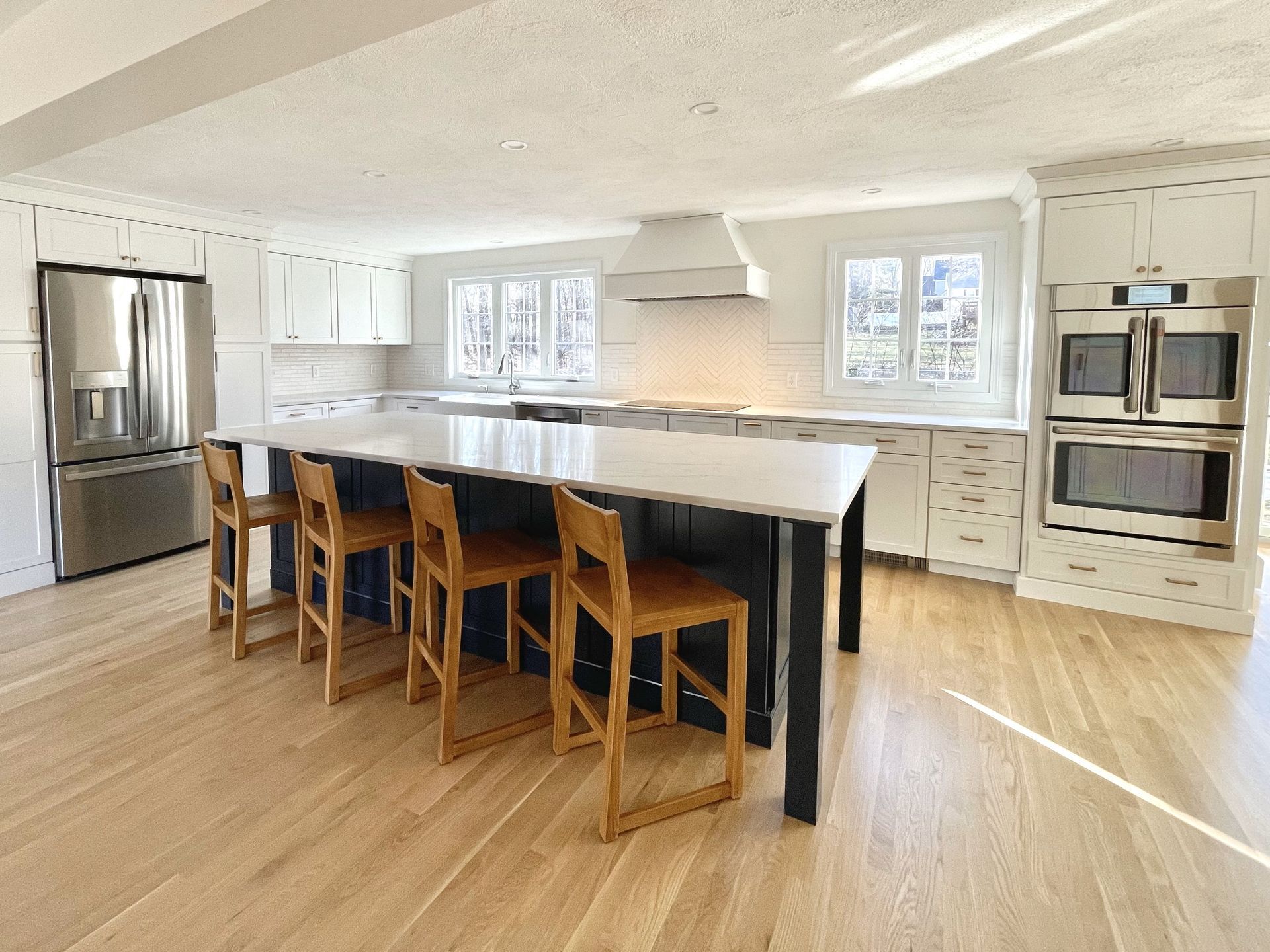 A kitchen with a large island and stools