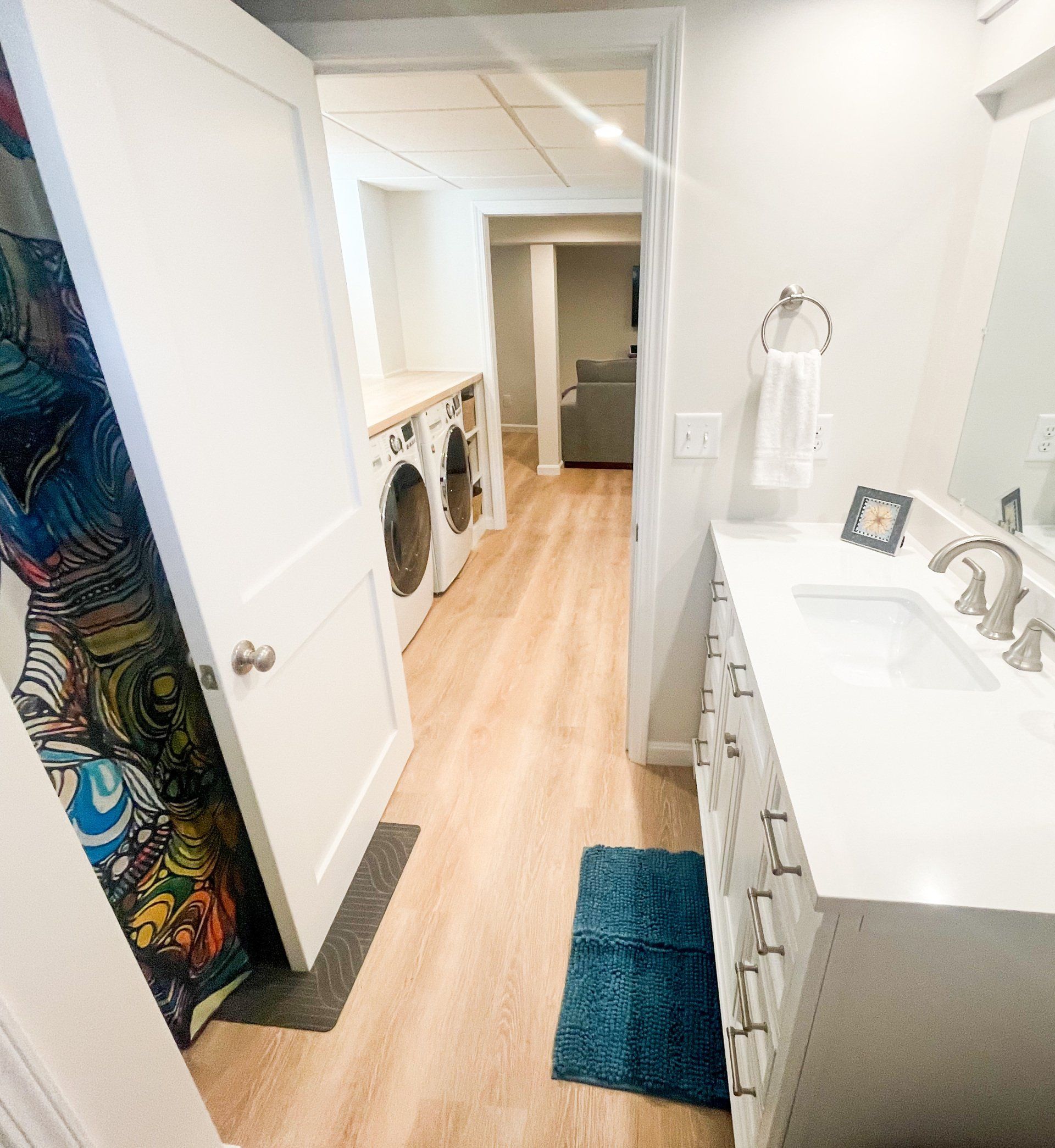 A bathroom with a sink and a washer and dryer