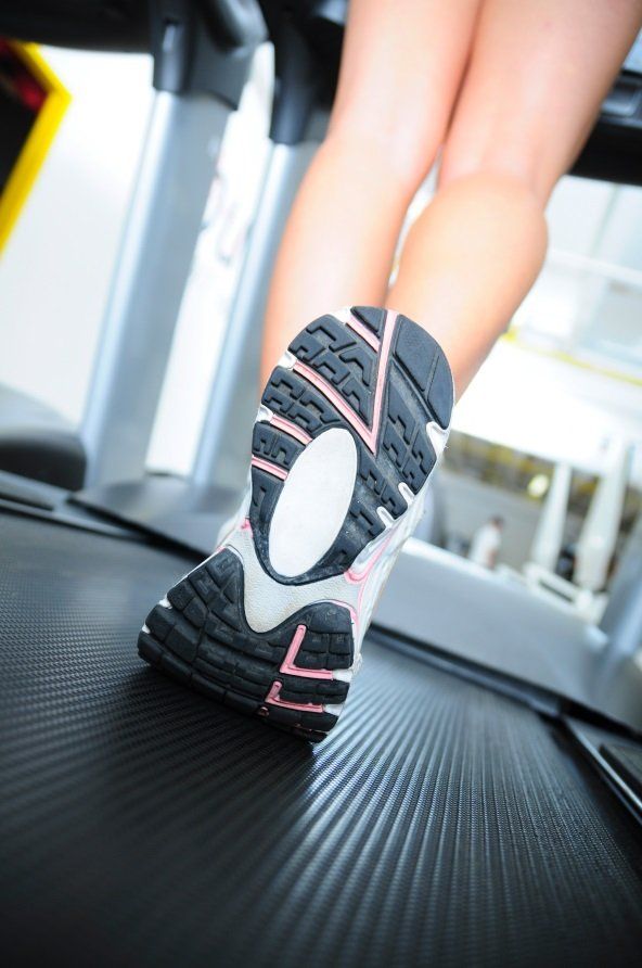 Close up shot of woman's shoes while on a treadmill