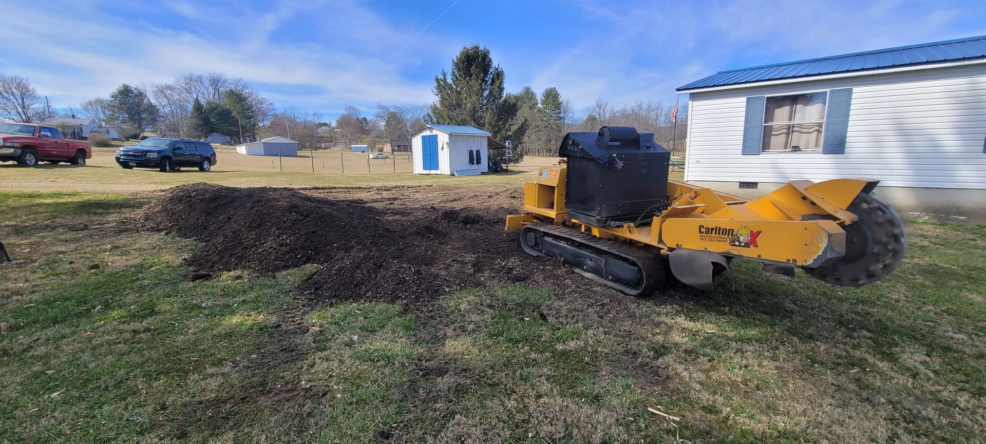 a yellow trx stump grinder grinds stump 1