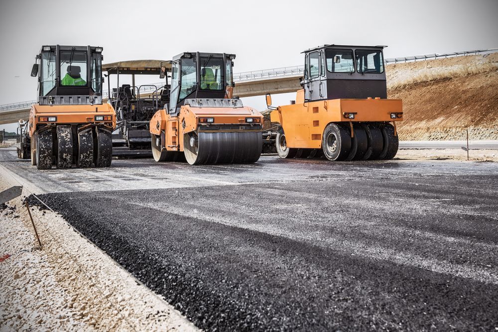 Three Asphalt Rollers Are Working on a Road Under Construction — Precious Drop Water in Stokers Siding, NSW