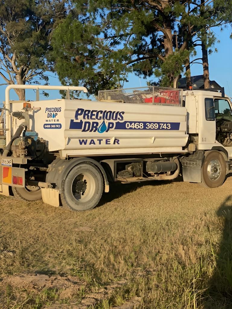 White Water Truck is Parked in a Grassy Field — Precious Drop Water in Stokers Siding, NSW