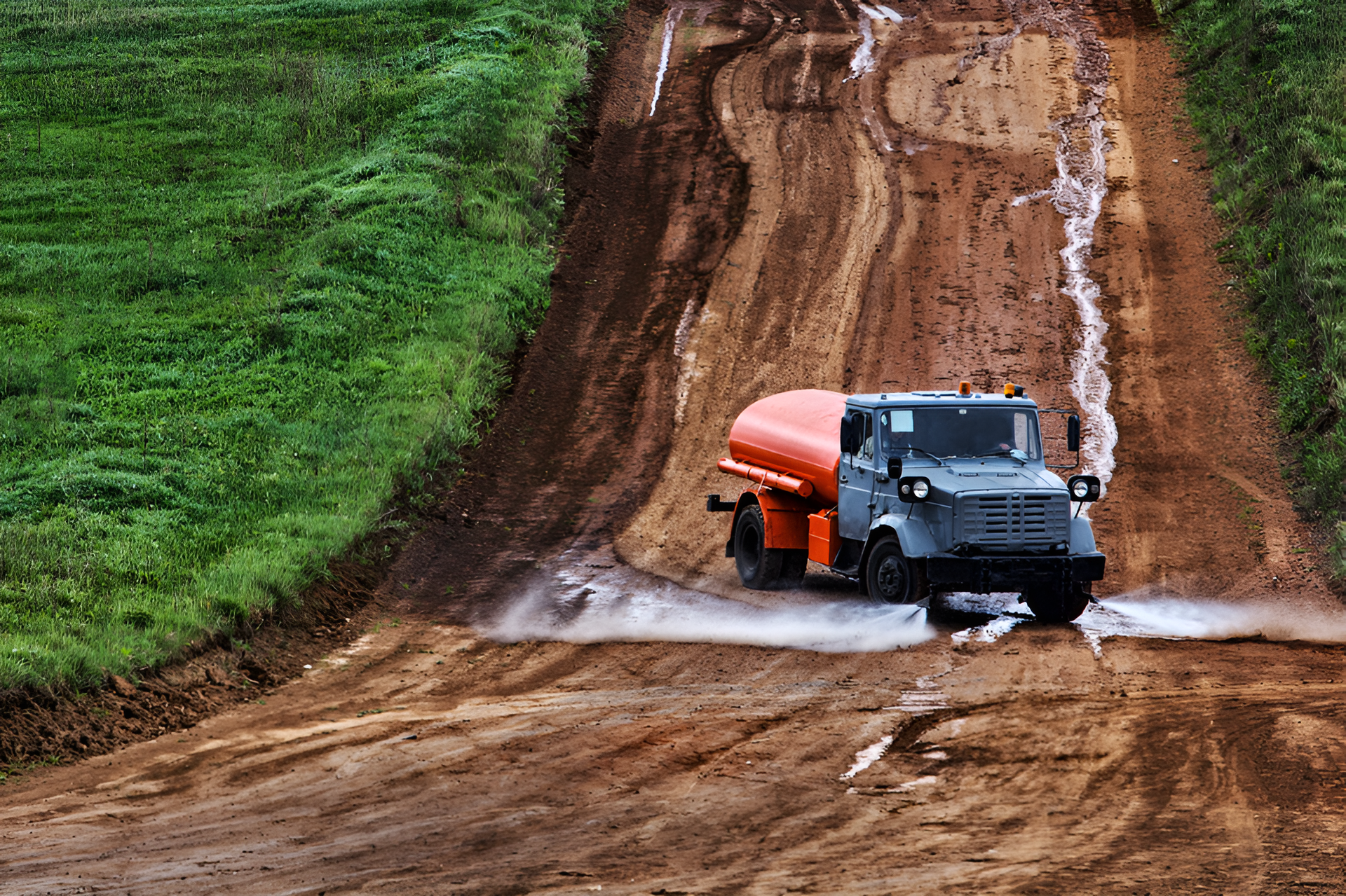Truck With a Red Tank is Driving Down a Dirt Road — Precious Drop Water in Murwillumbah, NSW