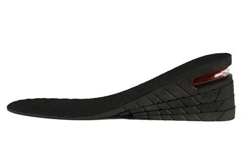 Plantillas ortopédicas para zapatos, una gris con soporte rojo y amarillo, y otra negra con borde blanco.