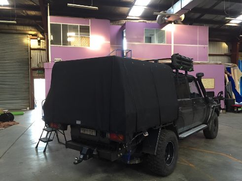 A Black Truck Is Parked In A Warehouse  — Western Tarps and Motor Trimming In Dubbo, NSW