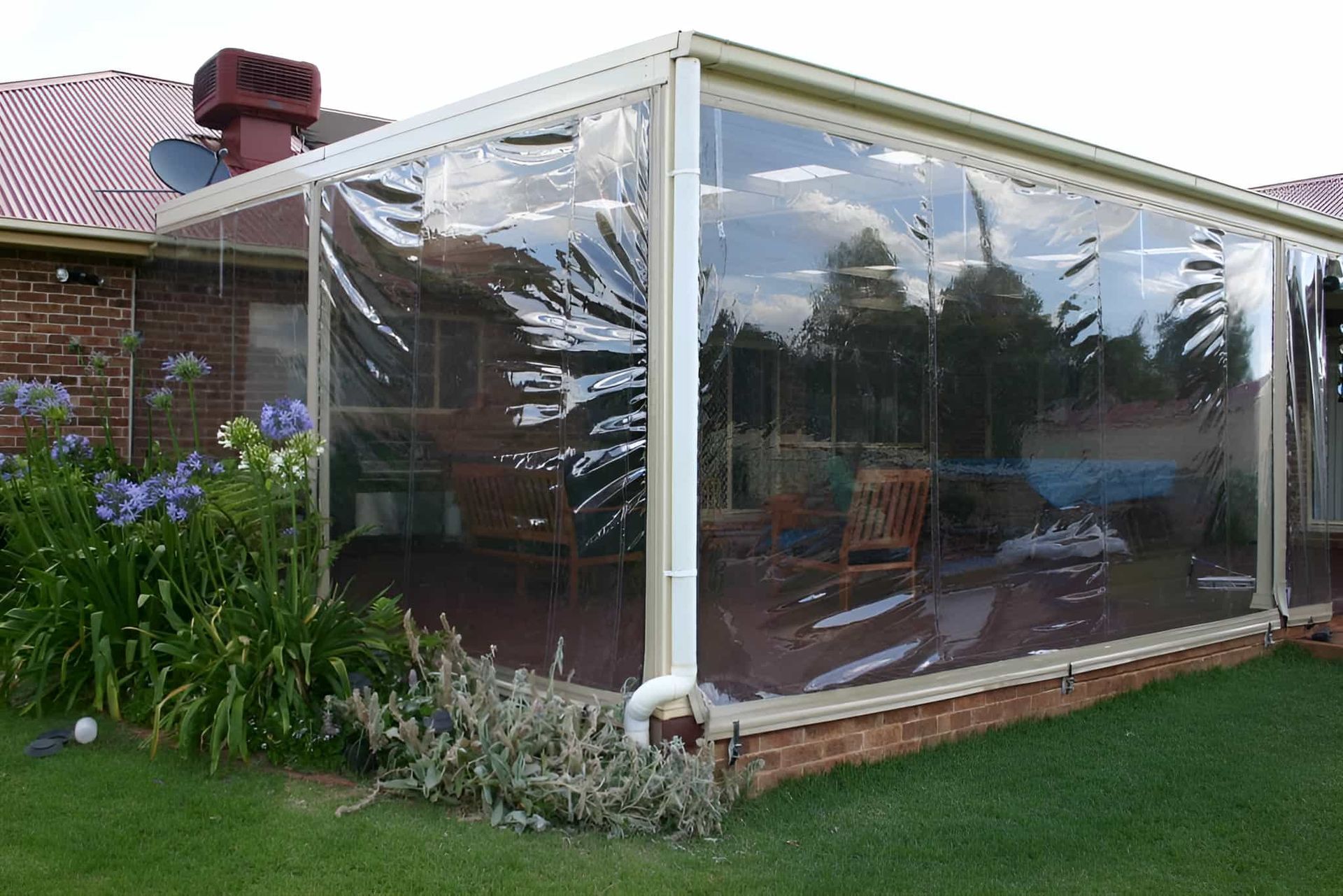 A Clear Canopy Is Covering A Patio In A Backyard — Western Tarps and Motor Trimming In Dubbo, NSW