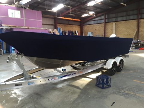 A Boat Is Sitting On A Trailer In A Warehouse — Western Tarps and Motor Trimming In Dubbo, NSW