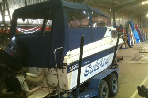 A Boat Is Sitting On A Trailer In A Warehouse — Western Tarps and Motor Trimming In Dubbo, NSW