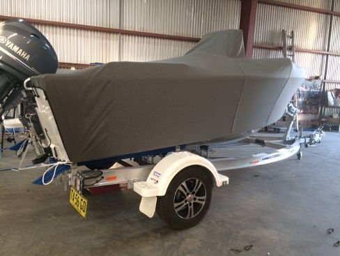A Boat With A Cover Is Sitting On A Trailer In A Warehouse — Western Tarps and Motor Trimming In Dubbo, NSW