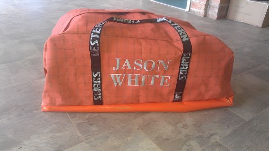 An Orange Duffel Bag With The Name Jason White On It — Western Tarps and Motor Trimming In Dubbo, NSW