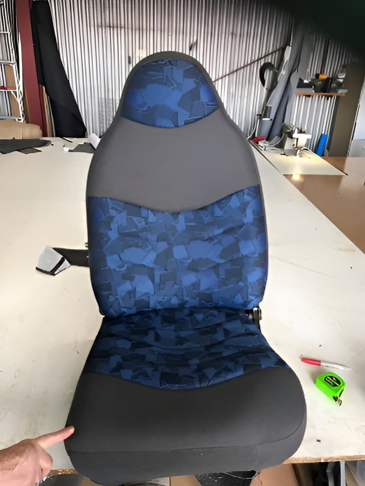 A Blue And Grey Car Seat Is Sitting On A Table — Western Tarps and Motor Trimming In Dubbo, NSW