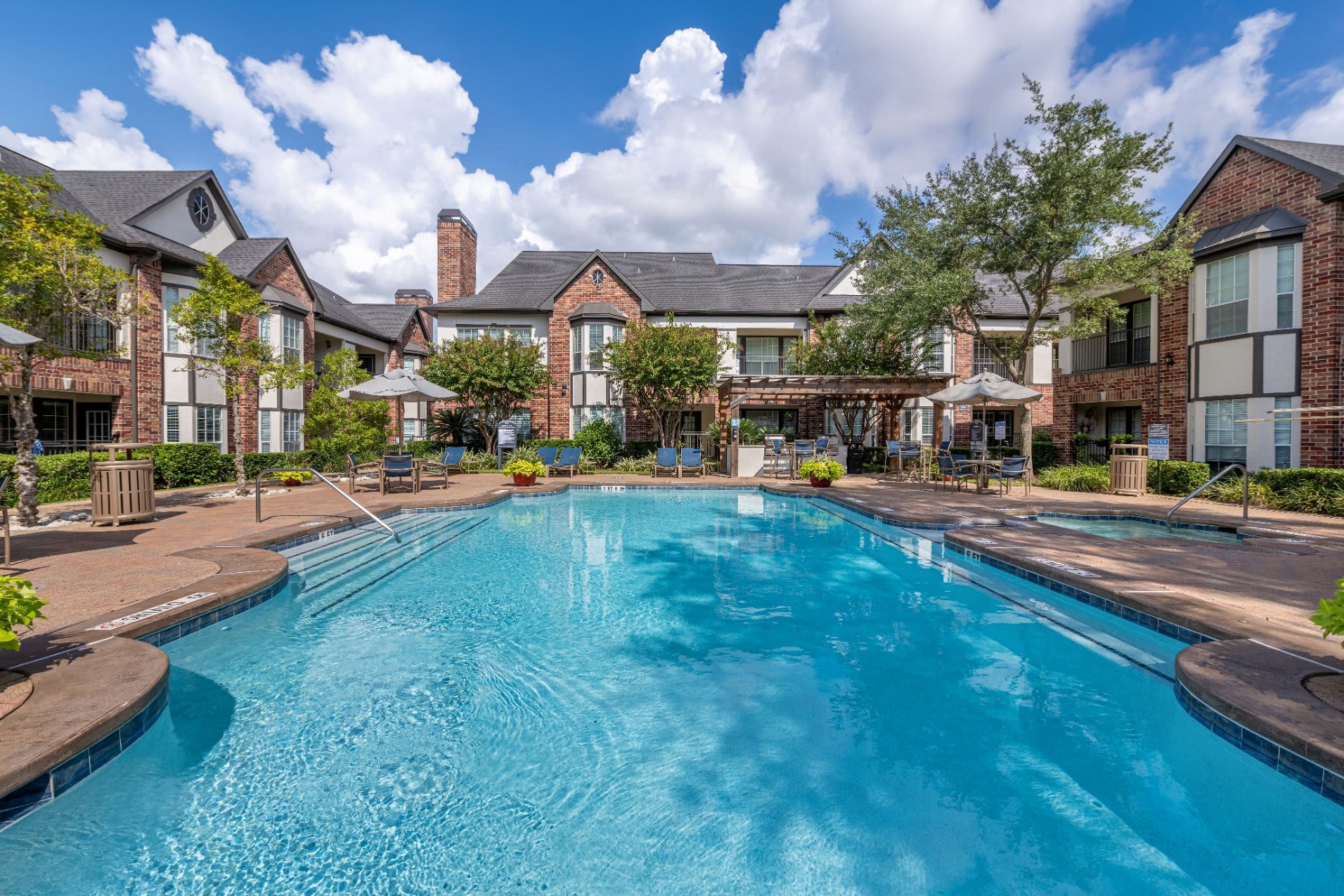 a large swimming pool in the middle of a residential area at Marquis on Memorial in Houston, TX.