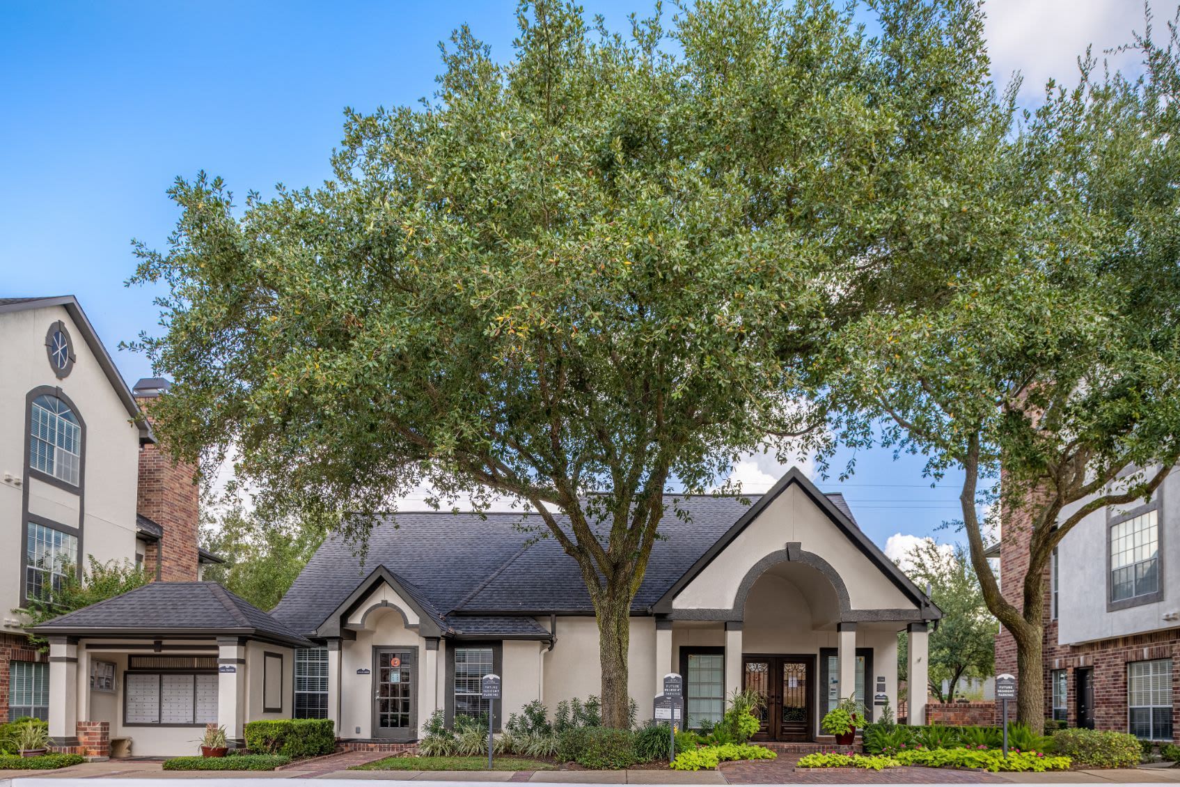 a large white house with a tree in front of it at Marquis on Memorial in Houston, TX.