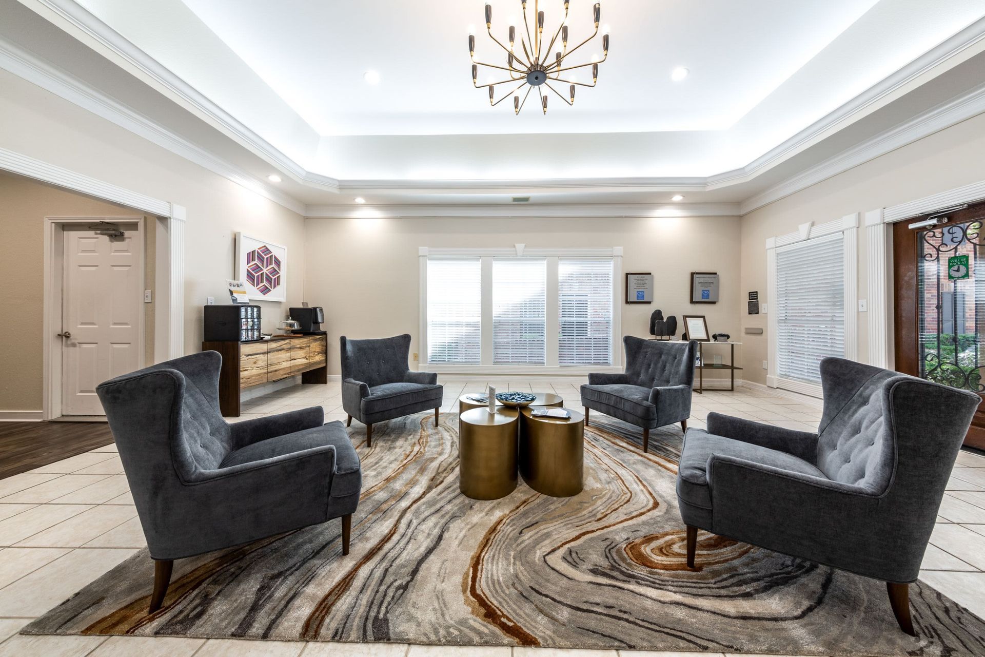 a living room filled with furniture and a chandelier at Marquis on Memorial in Houston, TX.