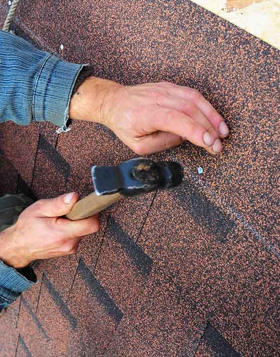 Roof Repair — Roofer Installs Bitumen Roof Shingles in Aurora, CO
