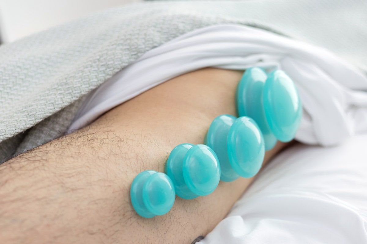 A person is laying in bed with a bracelet on their arm.