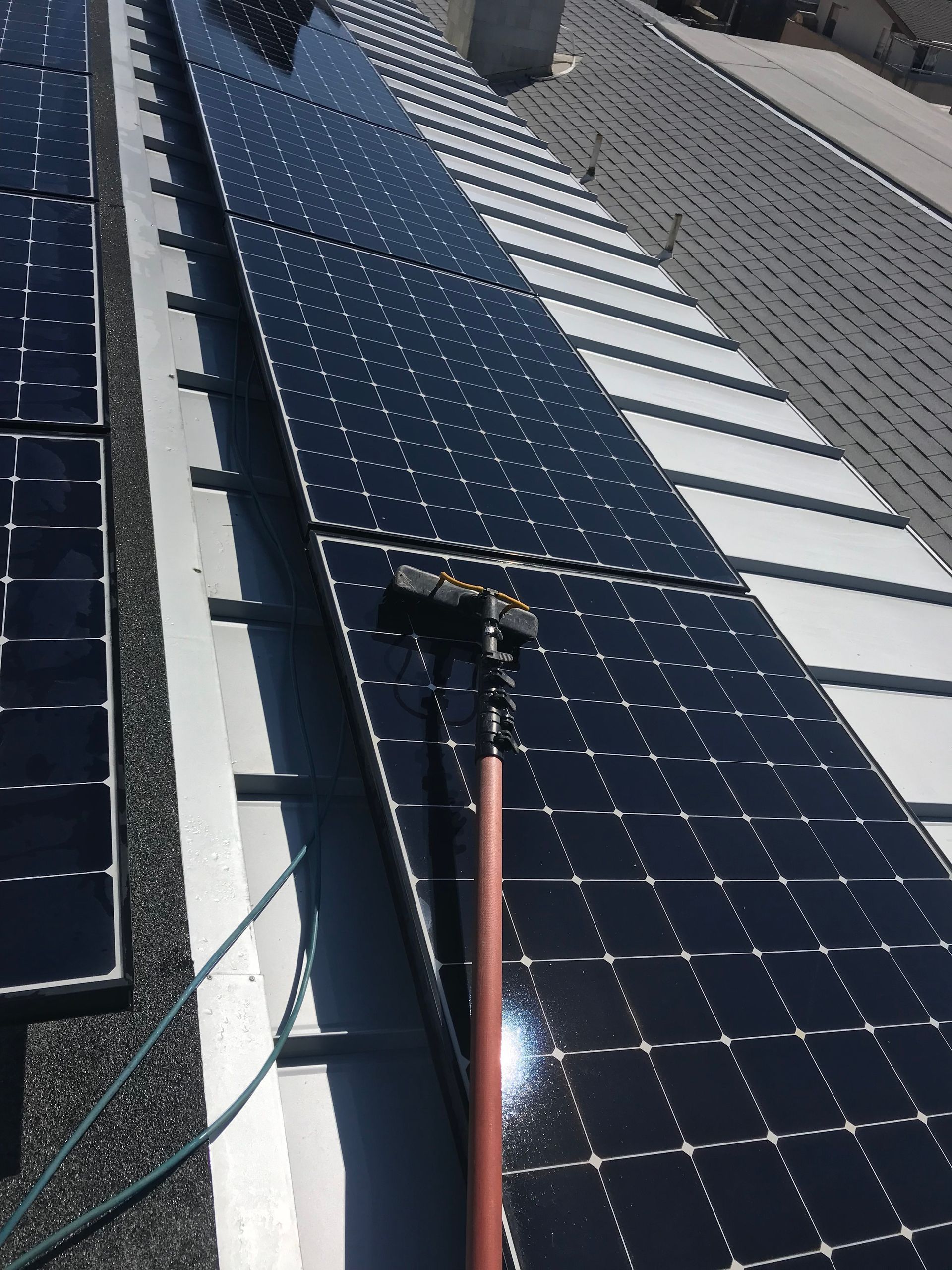 a solar panel is being cleaned on the roof of a building