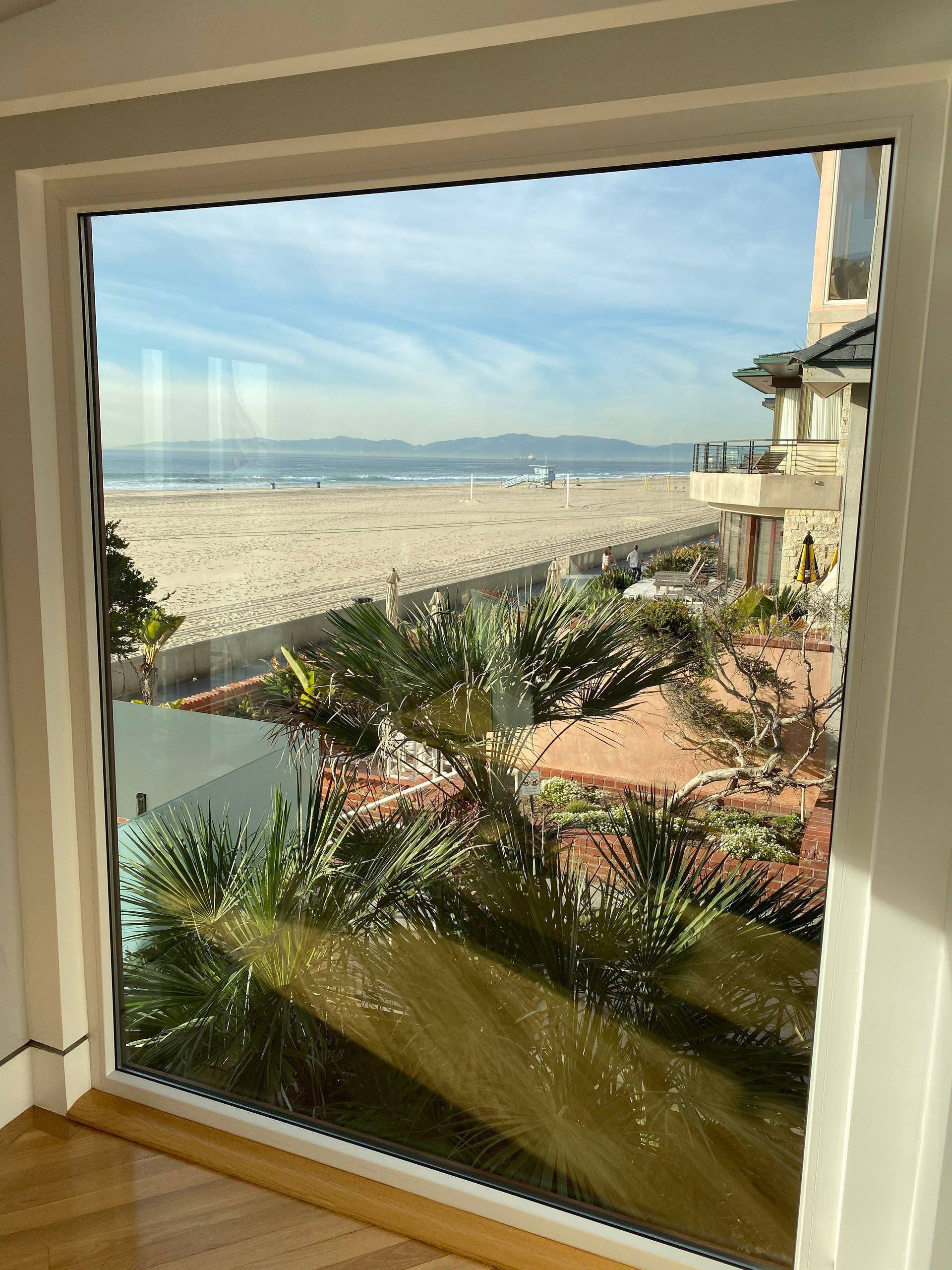 a large window with a view of the ocean and a beach