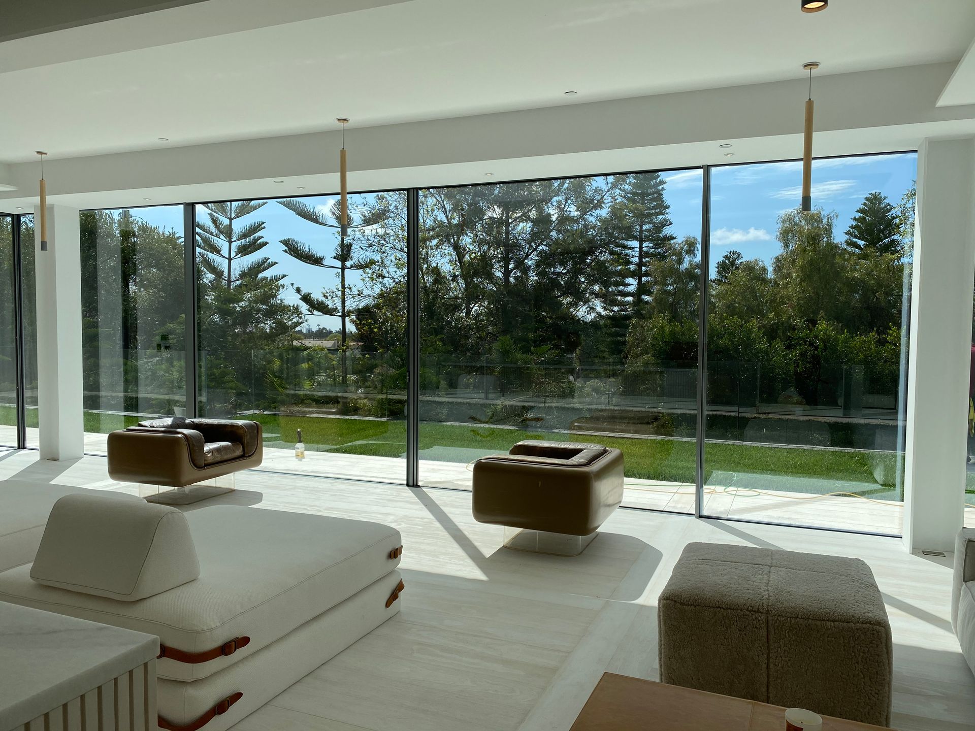 a living room with a lot of windows and furniture