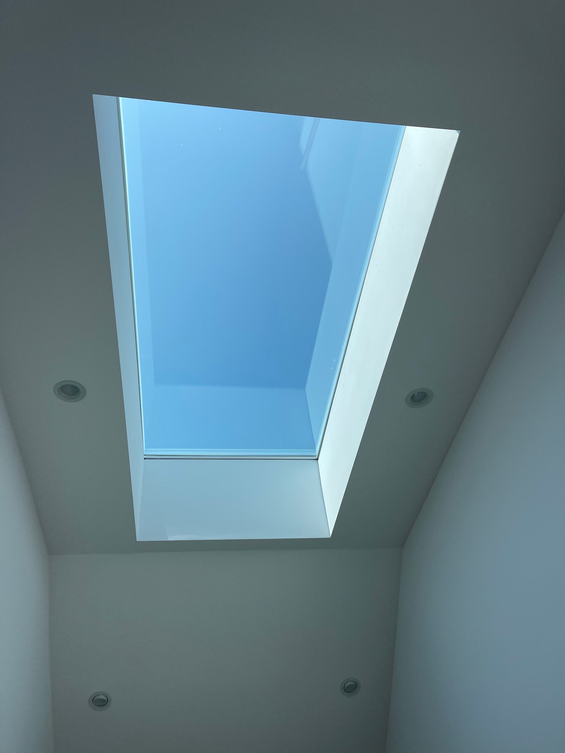 a skylight with a blue sky behind it