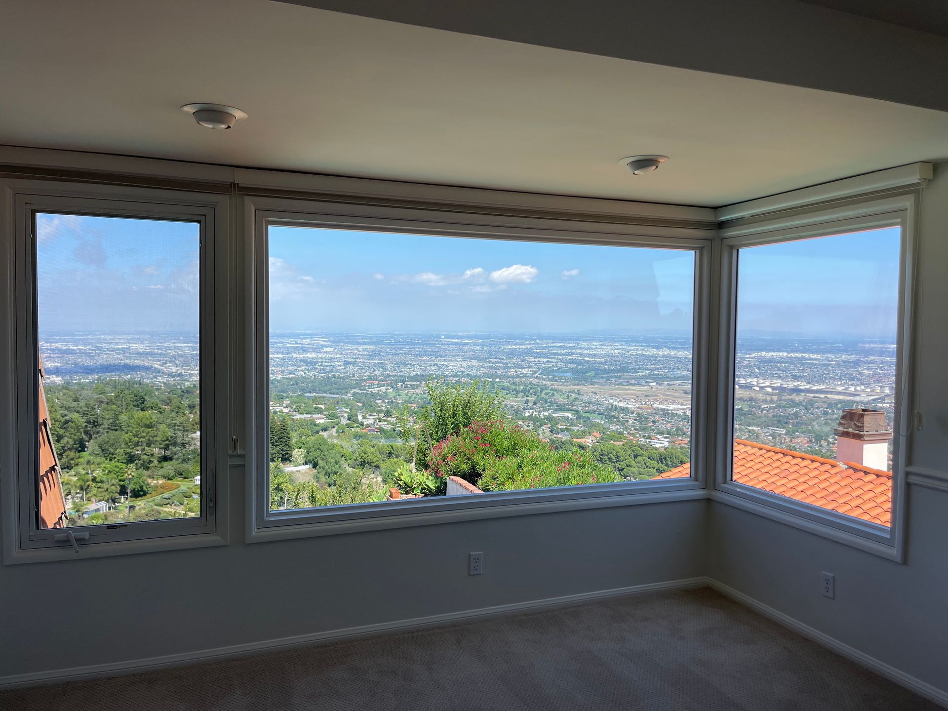 a large window with a view of a city and mountains