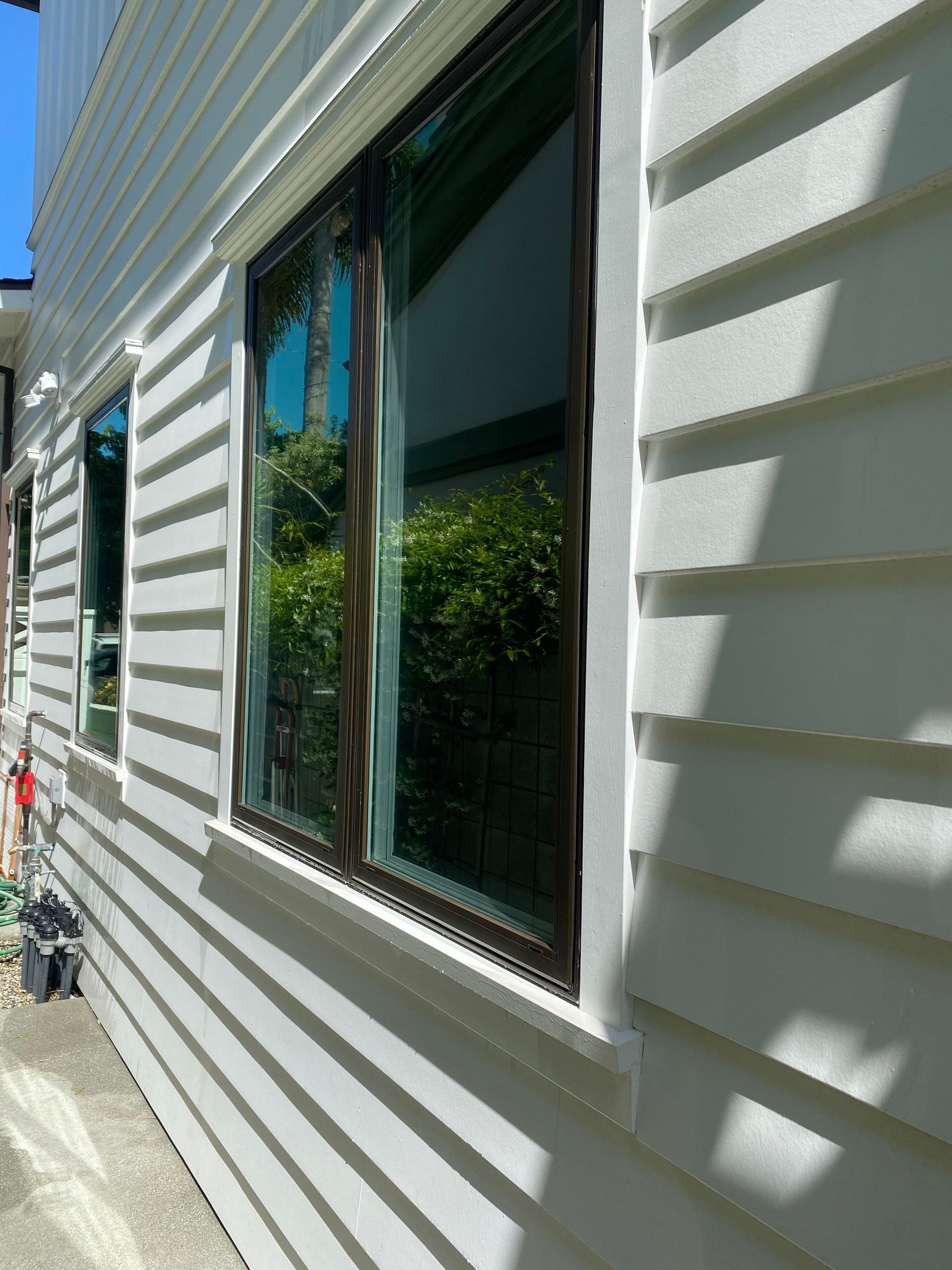 a white house with a lot of windows on the side of it .