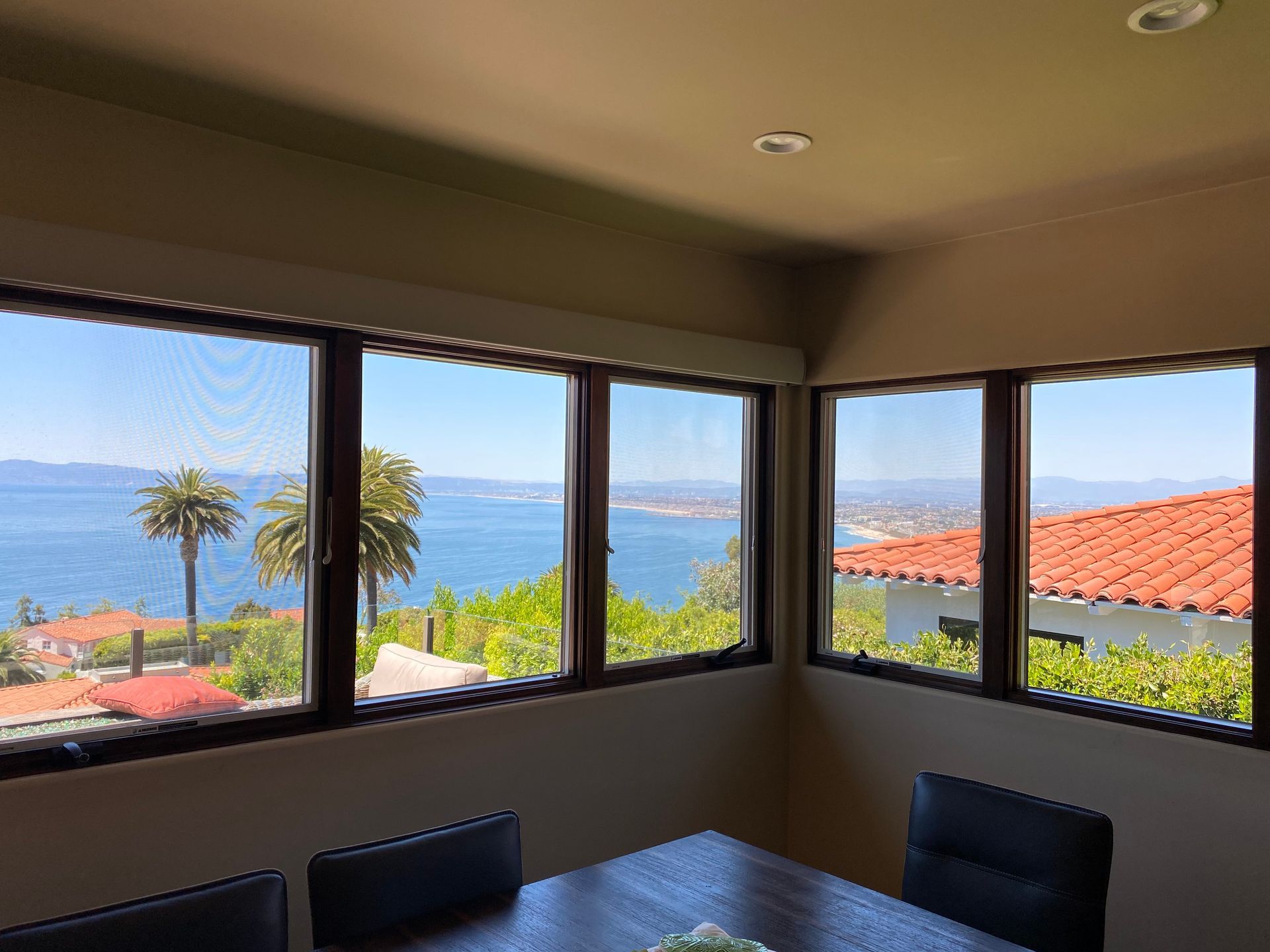 a dining room with a table and chairs and a view of the ocean