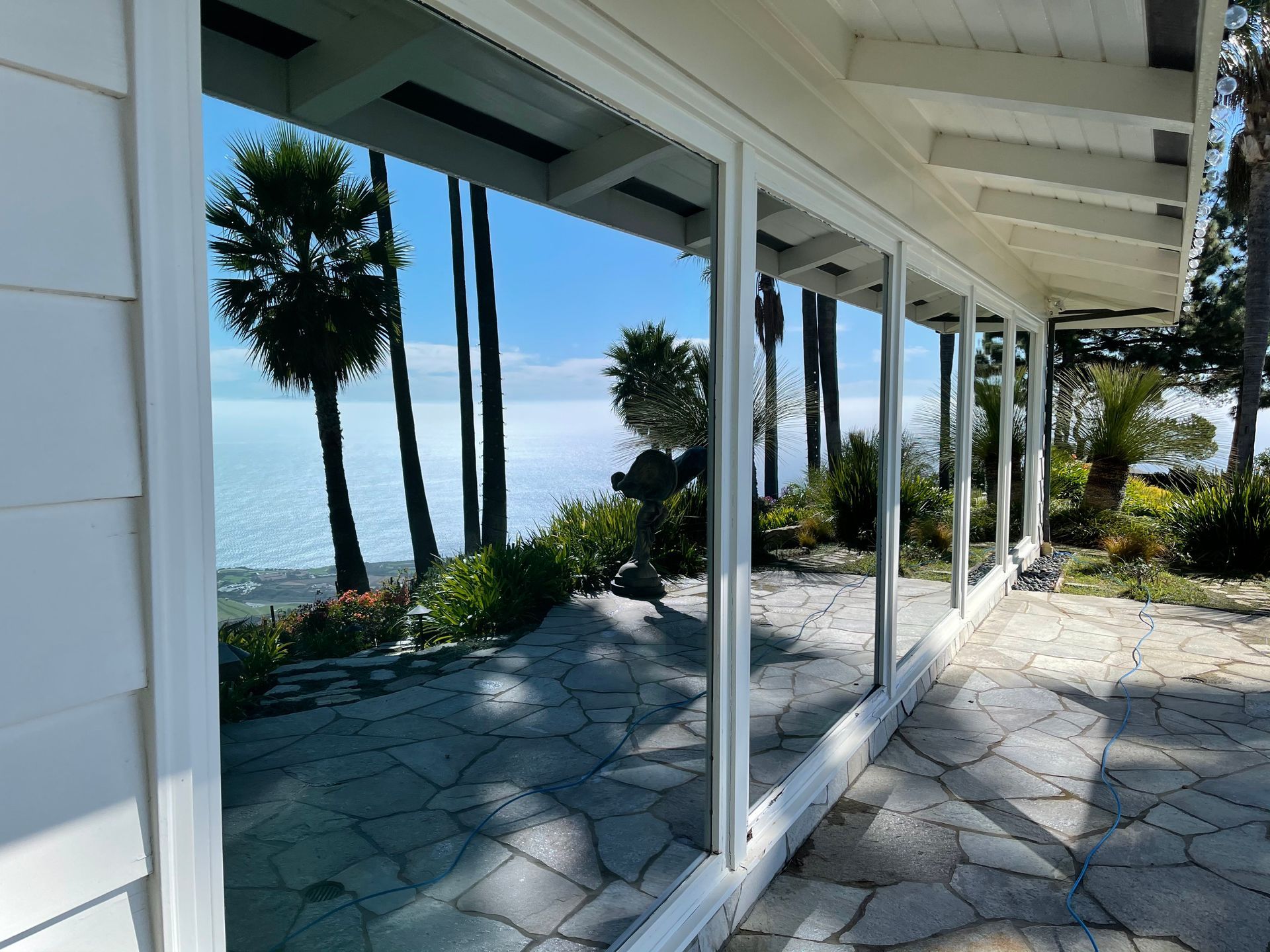 a house with a view of the ocean and palm trees