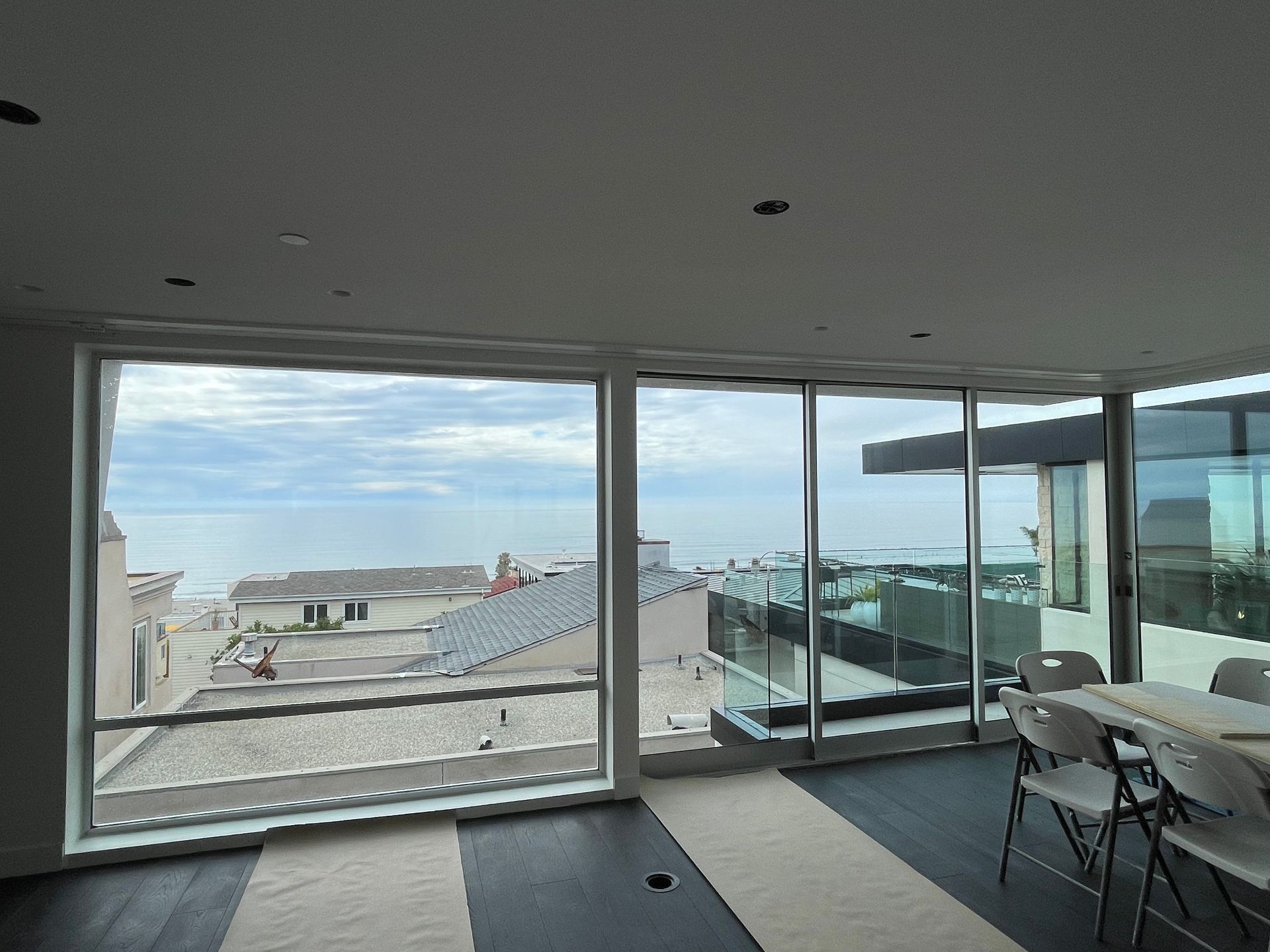 a room with a lot of windows and a view of the ocean