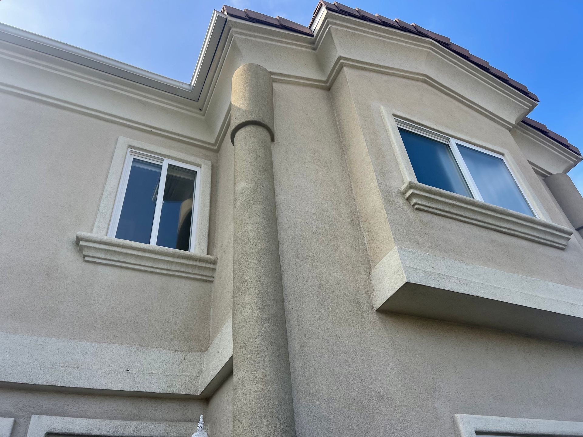 looking up at a house with a blue sky in the background