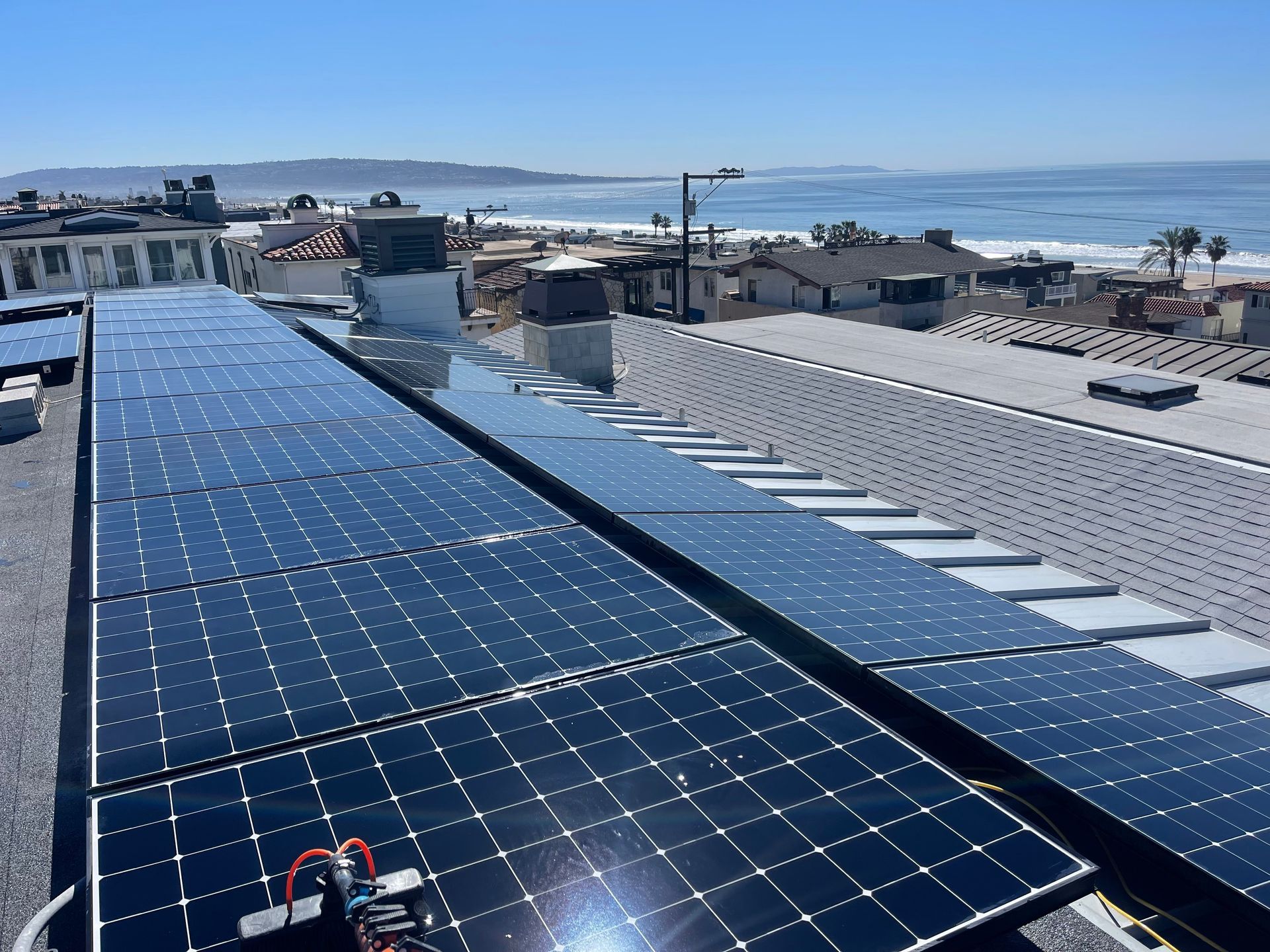 a row of solar panels on the roof of a building