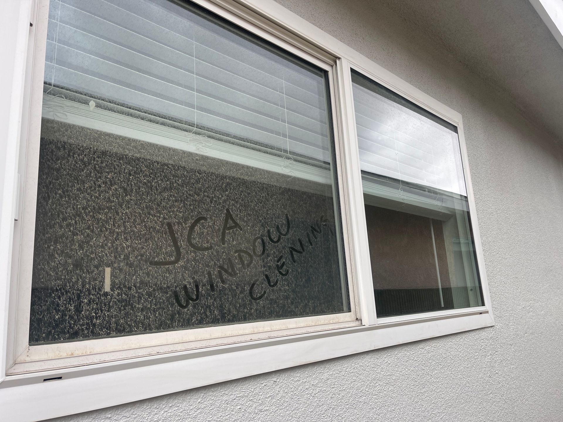 a window on a building with the word jca written on it